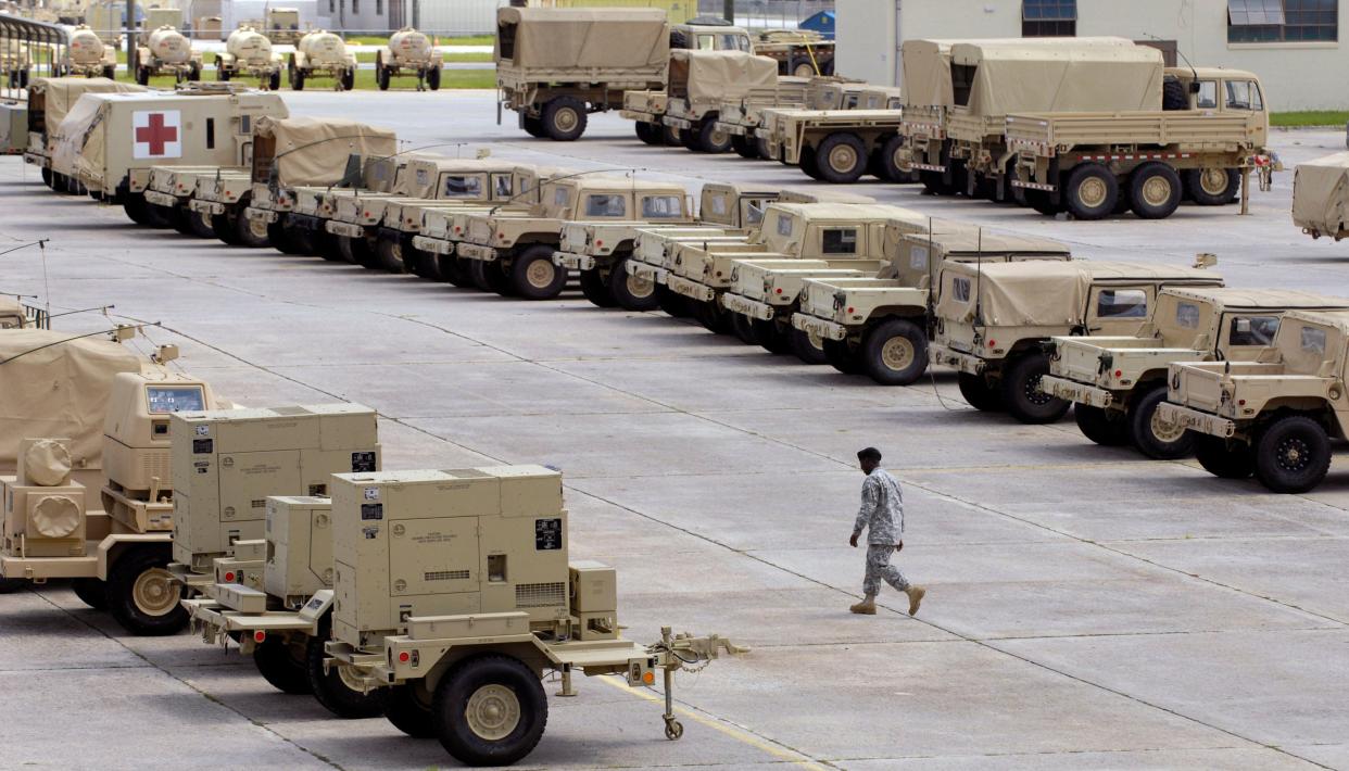 FILE - A soldier walks through the 4th Infantry Brigade Combat Team motor pool at Fort Stewart in Georgia on Aug. 24, 2009. A family was found dead in their home on base on Wednesday.