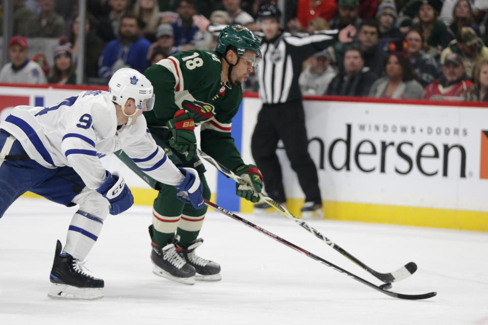 Minnesota Wild left wing Jordan Greenway (18) controls the puck in front of Toronto Maple Leafs center Jason Spezza (19) and Maple Leafs center Auston Matthews (34) in the first period of an NHL hockey game Tuesday, Dec. 31, 2019, in St. Paul, Minn. (AP Photo/Andy Clayton-King)