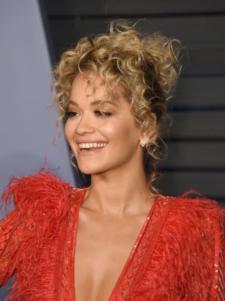<p>Rita Ora's messy updo is a lesson in using your curly texture to your advantage. An updo with cascading curls and face-framing tendrils will always feel romantic and youthful, while also looking polished.</p>