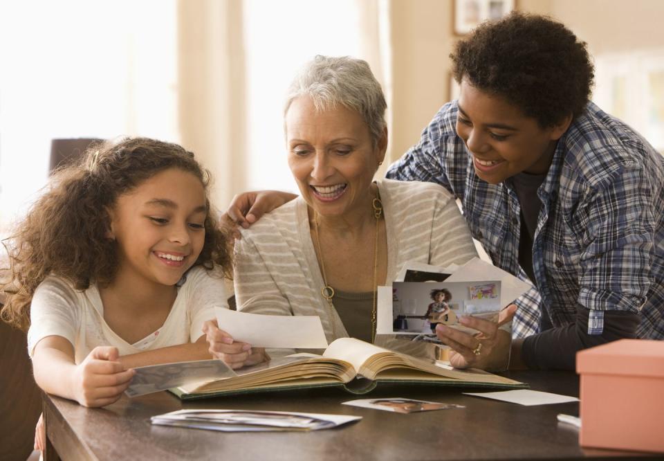 swedish death cleaning, grandmother and grandchildren looking at photos