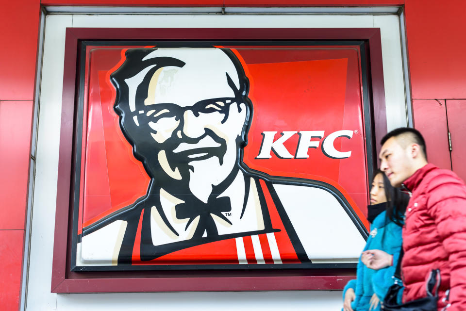 Harbin, China - January 13, 2015: Signboard of KFC. People are walking. Located in Harbin City, Heilongjiang Province, China.