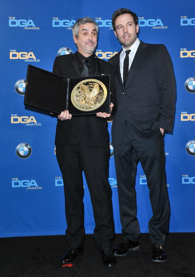 Alfonso Cuarón, left, and Ben Affleck pose in the press room of the the 66th Annual DGA Awards Dinner at the Hyatt Regency Century Plaza Hotel on Saturday, Jan. 25, 2014, in Los Angeles, Calif. (Photo by Richard Shotwell Invision/AP)