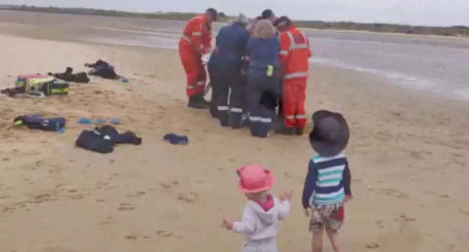 Paramedics attend to the man. He’s credited them with saving his life. Source: 7 News