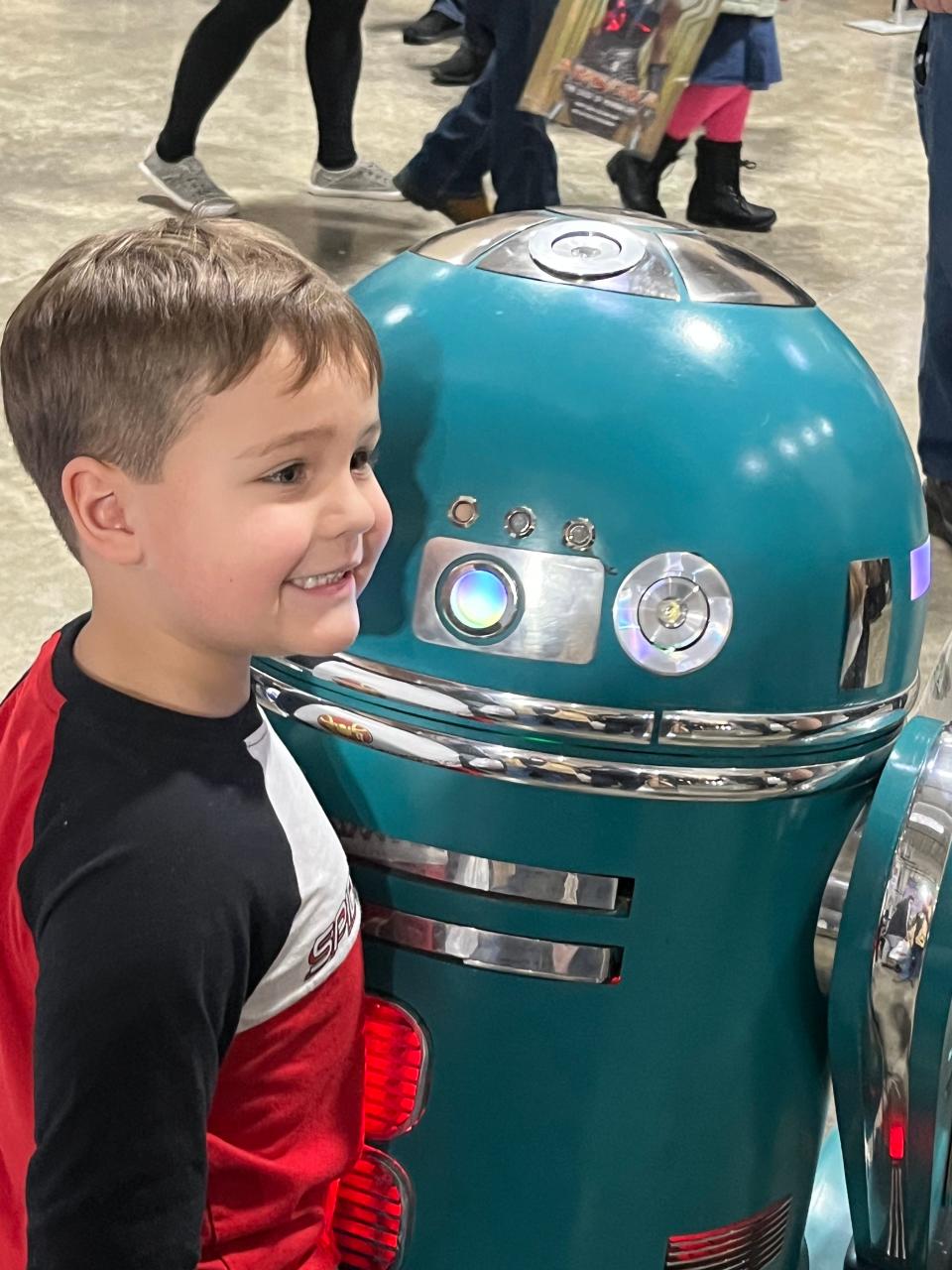 Milo Acker of Granger liked the friendly droid Artoo Deco that the R2 Builder Club of Fort Wayne used to entertain guests at the Comic Con. The club also uses the droids to inspire STEM studies.
