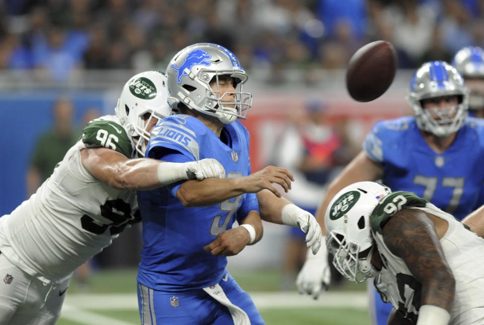 New York Jets defensive end Henry Anderson (96) hits Detroit Lions quarterback Matthew Stafford's (9) arm as he throws during the second half of an NFL football game in Detroit, Monday, Sept. 10, 2018. (AP Photo/Jose Juarez)