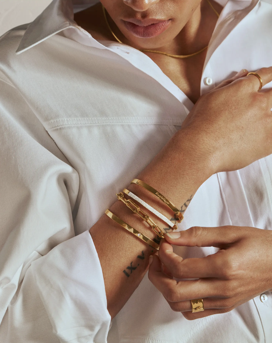 model in white blouse wearing gold and diamond bracelets, Monica Vinader Essential Pavé Diamond Bangle (Photo via Nordstrom)