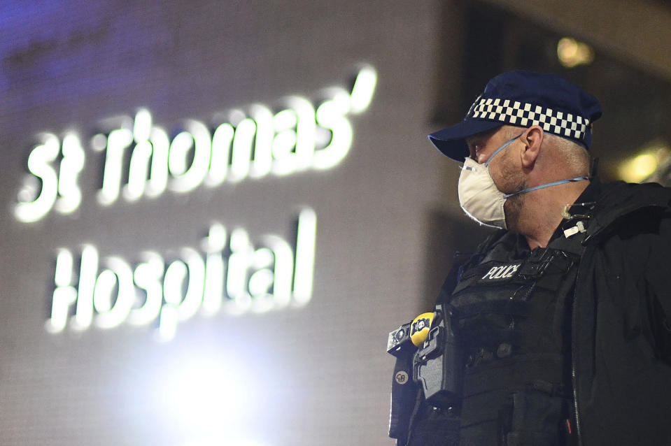 A police officer stands outside St Thomas' Hospital in central London as British Prime Minister Boris Johnson was moved to intensive care after his coronavirus symptoms worsened on Monday April 6, 2020. Johnson was admitted to St Thomas' hospital in central London on Sunday after his coronavirus symptoms persisted for 10 days. Having been in hospital for tests and observation, his doctors advised that he be admitted to intensive care on Monday evening. (Victoria Jones/PA via AP)