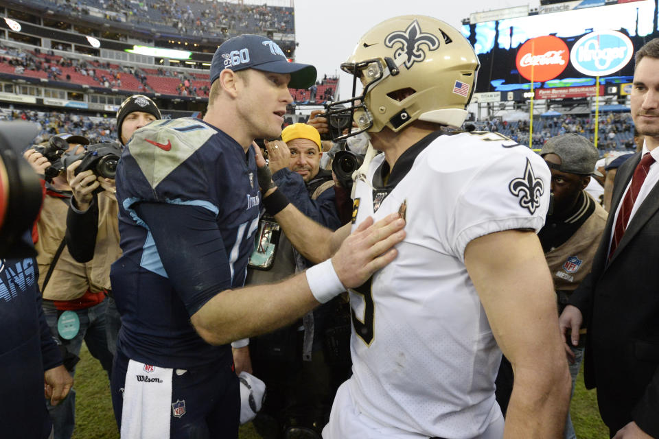 Tennessee Titans quarterback Ryan Tannehill, left, and New Orleans Saints quarterback Drew Brees meet on the field after an NFL football game Sunday, Dec. 22, 2019, in Nashville, Tenn. The Saints won 38-28. (AP Photo/Mark Zaleski)