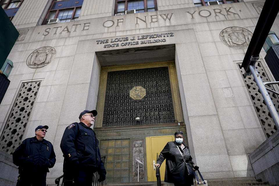 FILE - Court officers stand guard outside the public entrance to the 80 Centre Street building where a grand jury investigating former President Donald Trump over hush money payments is back in court and hearing evidence related to the case, March 27, 2023, in New York. (AP Photo/John Minchillo, File)