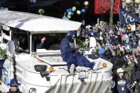 Seattle Seahawks running back Marshawn Lynch rides on the hood of a vehicle during the parade for the NFL football Super Bowl champions, Wednesday, Feb. 5, 2014, in Seattle. The Seahawks defeated the Denver Broncos 43-8 on Sunday. (AP Photo/Ted S. Warren)