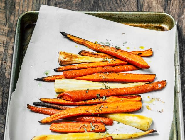 Parchment paper can save you from having to clean up greasy messes on your baking sheets. (Photo: Claudia Totir via Getty Images)