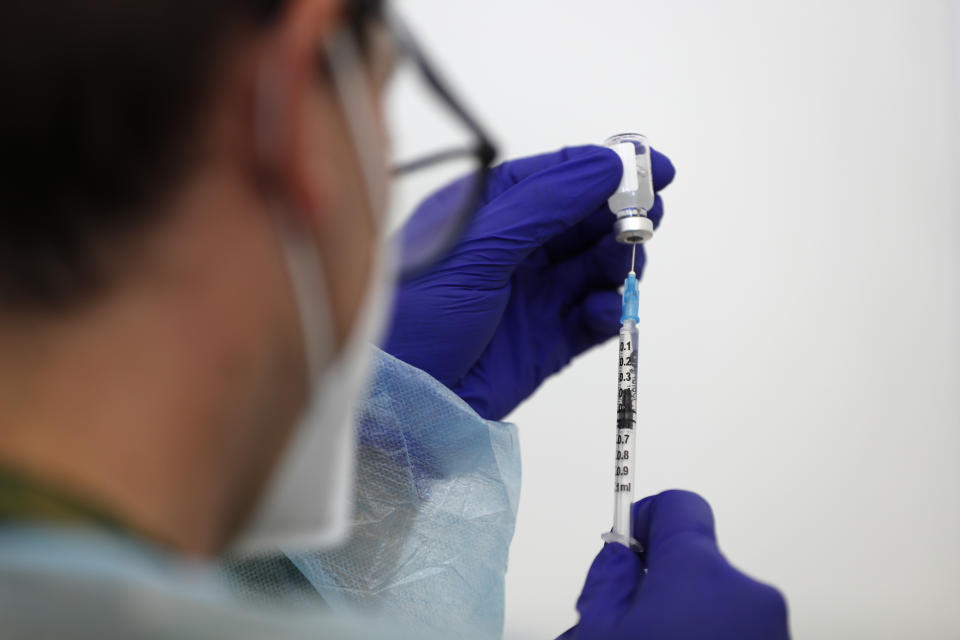 A nurse prepares doses of the Johnson & Johnson vaccine at an inoculation center operated by the Portuguese armed forces at Lisbon University's sports stadium, Wednesday, June 23, 2021. The Lisbon region's recent surge in COVID-19 cases is powering ahead, with new infections pushing Portugal's number of daily cases to a four-month high, as a report by health experts found fault with the government's pandemic response. (AP Photo/Armando Franca)