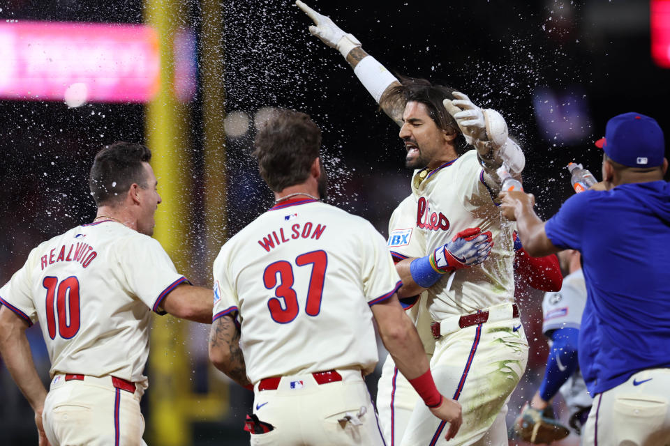 Nick Castellanos celebrates with his Phillies teammates after a walk-off single against the Mets. (Rob Tringali/MLB Photos via Getty Images)