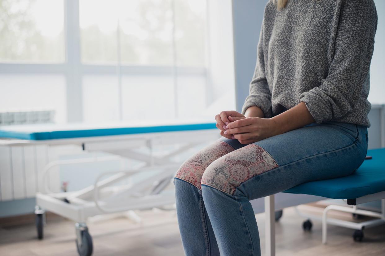 Woman's hand waiting for doctor in hospital feeling worried