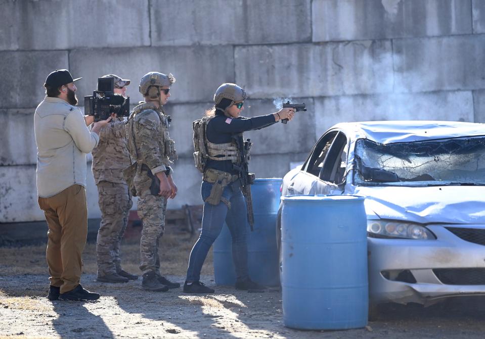 Former Congresswoman Tulsi Gabbard fires a pistol at targets during the 2021 Tactical Challenge at the U.S. Army John F. Kennedy Special Warfare Center and School's Miller Training Complex on Dec. 16, 2021. Twelve celebrities teamed up with Green Berets to take part in the annual event.