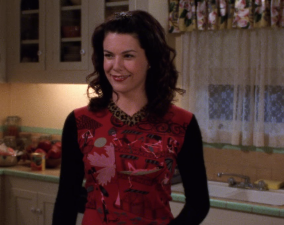 Ah, now we really get down to it. Lorelai hosts Rory's birthday party in a long-sleeve shirt so achingly aughts, with its contrasting prints, long sleeves, V-neck and vivid colors, that it's almost hard to believe.