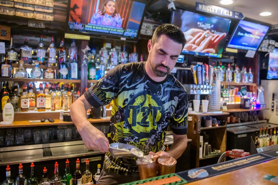 Co-owner and bartender Dan Gilfillan works behind the bar at MD's Sports Bar and Grill on N. University in Peoria.