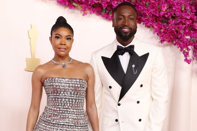 <p>Kevin Mazur/Getty</p> Gabrielle Union-Wade and Dwyane Wade attend the 96th Annual Academy Awards