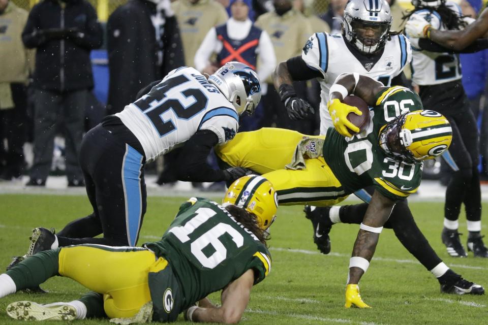 Green Bay Packers' Jamaal Williams is stopped on a run during the first half of an NFL football game against the Carolina Panthers Sunday, Nov. 10, 2019, in Green Bay, Wis. (AP Photo/Mike Roemer)
