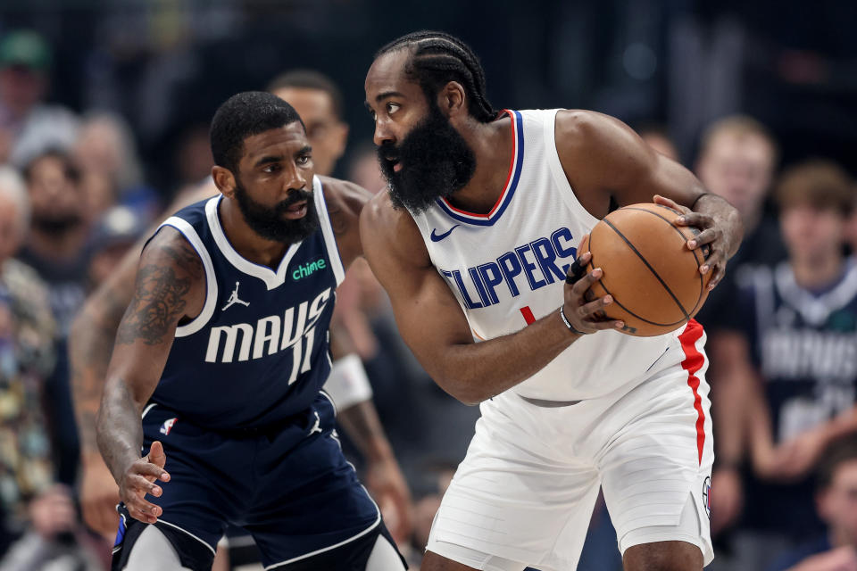 DALLAS, TEXAS - APRIL 28: James Harden #1 of the Los Angeles Clippers controls the ball while defended by Kyrie Irving #11 of the Dallas Mavericks in the first half of game four of the Western Conference First Round Playoffs at American Airlines Center on April 28, 2024 in Dallas, Texas.  NOTE TO USER: User expressly acknowledges and agrees that, by downloading and or using this photograph, User is consenting to the terms and conditions of the Getty Images License Agreement. (Photo by Tim Warner/Getty Images)