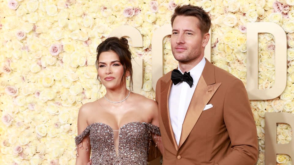 Actress Sofia Pernas was all sparkle and tulle in an ombre off-the-shoulder mermaid dress by Pamella Roland. Her husband, “This is Us” star Justin Hartley, wore an ochre Nana Sartoria tuxedo paired with dark bowtie, black patent Oxfords by Christian Louboutin and a Rolex watch. - Michael Tran/AFP/Getty Images