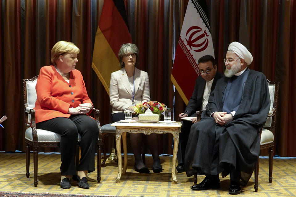 In this photo released by the official website of the office of the Iranian Presidency, President Hassan Rouhani, right, meets Germany's Chancellor Angela Merkel, left, on the sideline of the United Nations General Assembly at the United Nations Headquarters Tuesday, Sept. 24, 2019. (Iranian Presidency Office via AP)