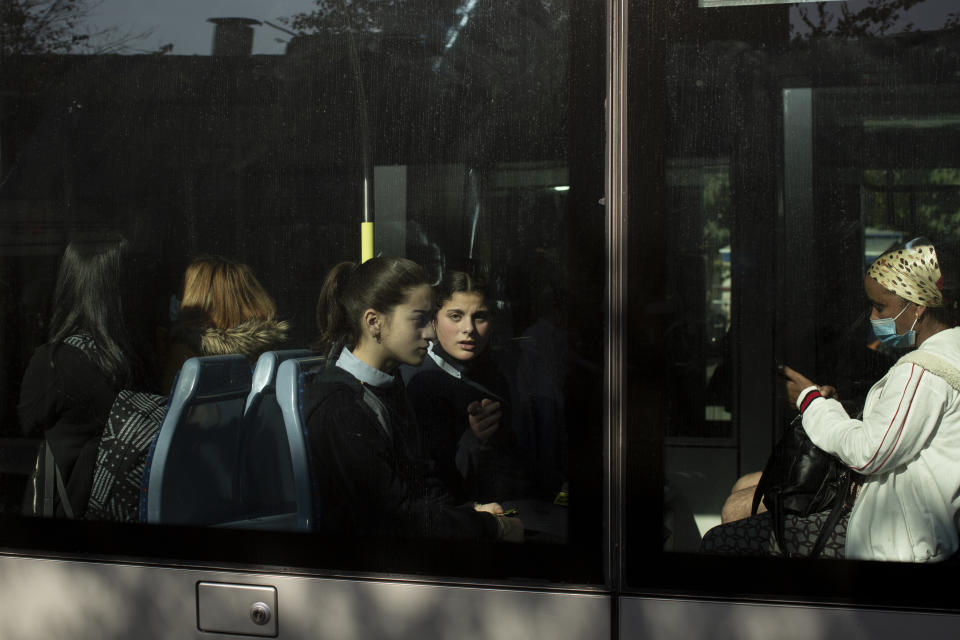 Girls ride the light rail in Jerusalem ahead of Shabbat, Friday, Nov. 26, 2021. Israel's prime minister says it is "on the threshold of an emergency situation" after authorities detected the country's first case of a new coronavirus variant in a traveler who returned from Malawi. (AP Photo/Maya Alleruzzo)