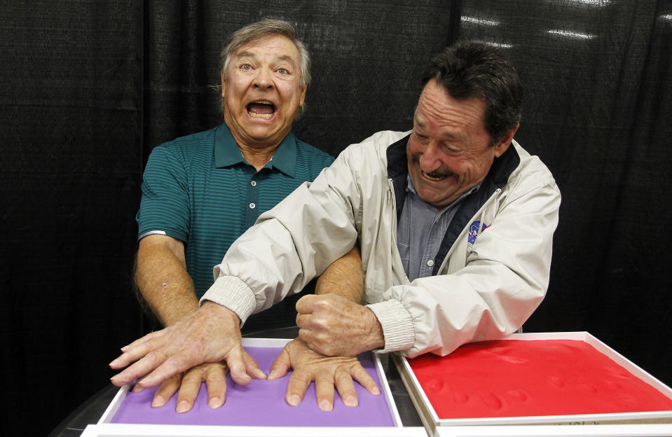 Peter Cullen, right, helps Frank Welker, the voice of Megatron, make handprints in Play-Doh compound at HASCON, the first-ever FANmily™ event from Hasbro, Inc. on Sept. 10, 2017, in Providence, R.I. (Stew Milne/AP Images for Hasbro, Inc.)