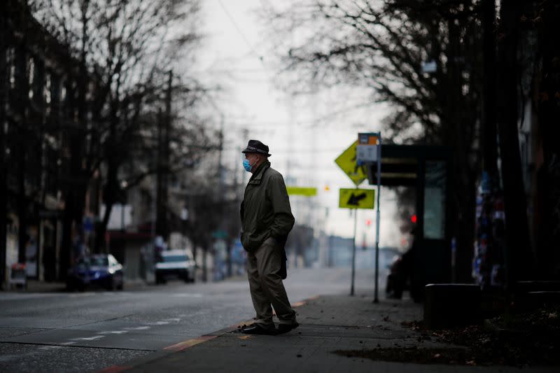 A man waits for a bus amid the coronavirus disease outbreak in Seattle