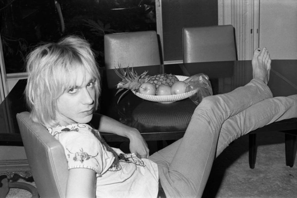 A young Iggy Pop with his feet on the table