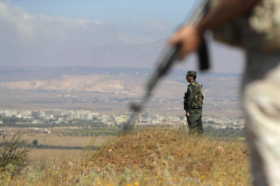 Syrian army soldier stands guard near the village of Tal Kroum, Syria, Tuesday, Aug. 14, 2018. The Russian military said Tuesday that its forces in Syria will help U.N. peacekeepers fully restore patrols along the frontier with the Israeli-occupied Golan Heights, reflecting Moscow's deepening role in mediating between the decades-old foes. (AP Photo/Sergei Grits)