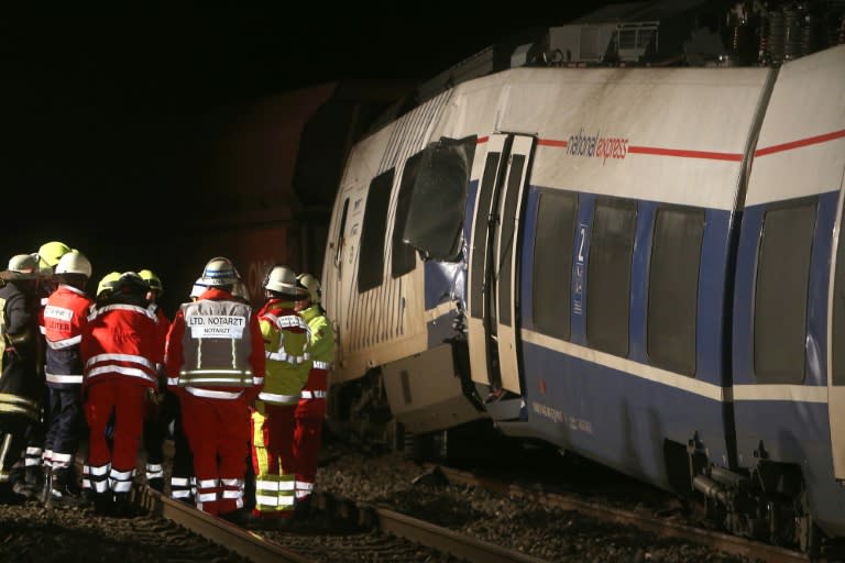 Firefighters work at the site of a train accident on December 5, 2017 in Meerbusch-Osterath, western Germany