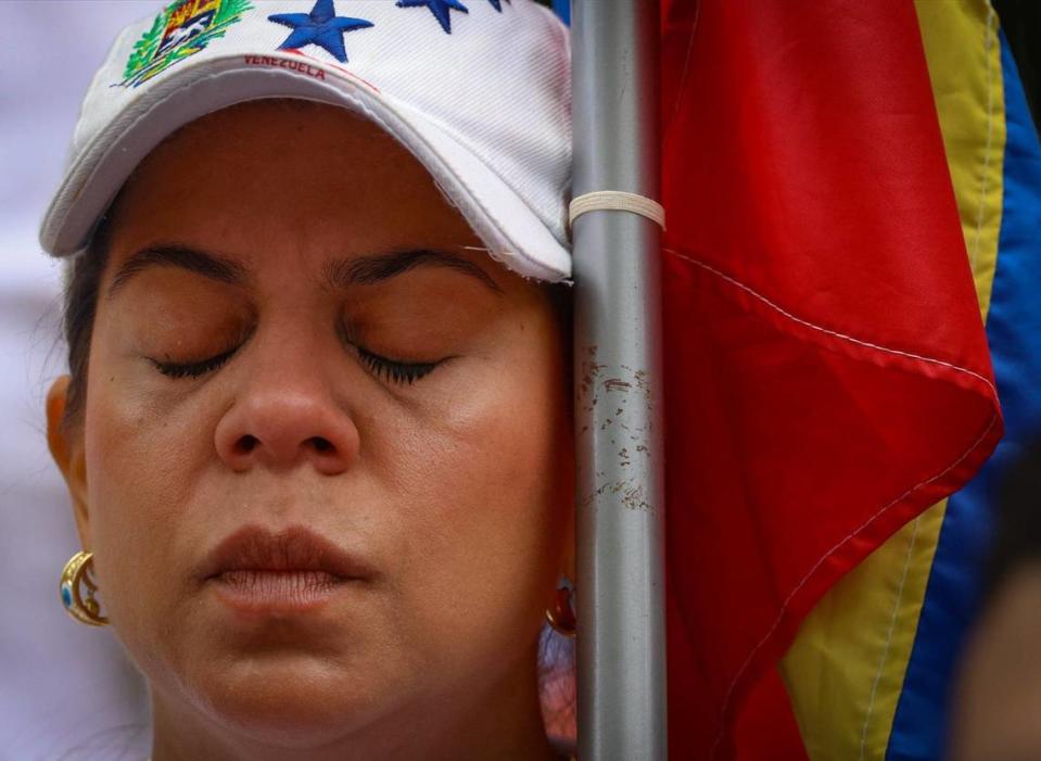 Isaura Inciarte closes her eyes during the signing of the Venezuelan National Anthem at the demonstration for the right to vote in the Venezuelan election. A group of about sixty people gathered at the former Venezuelan consulate in protest of their voting denial in the Venezuelan election on Sunday, July 28, 2024, in Miami, Florida.