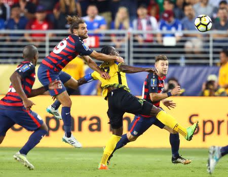 Jul 26, 2017; Santa Clara, CA, USA; United States midfielder Graham Zusi (19) pulls down Jamaica forward Darren Mattocks in the second half during the CONCACAF Gold Cup final at Levi's Stadium. Zusi would receive a yellow card penalty on the play. Mandatory Credit: Mark J. Rebilas-USA TODAY Sports