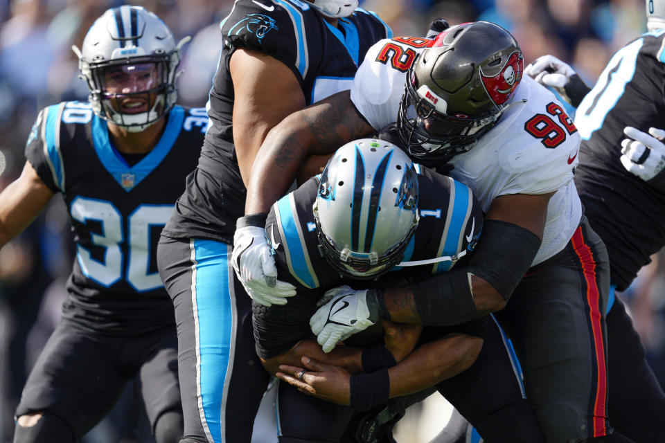Carolina Panthers quarterback Cam Newton is sacked by Tampa Bay Buccaneers defensive end William Gholston during the first half of an NFL football game Sunday, Dec. 26, 2021, in Charlotte, N.C. (AP Photo/Jacob Kupferman)
