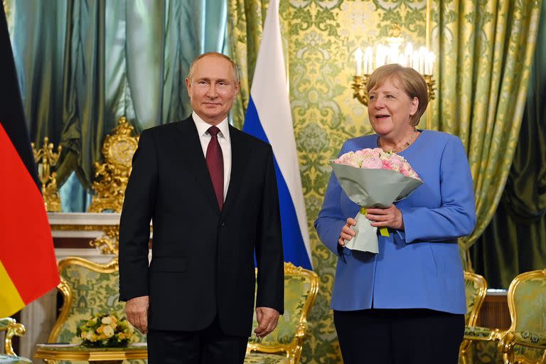 Vladimir Putin y Angela Merkel