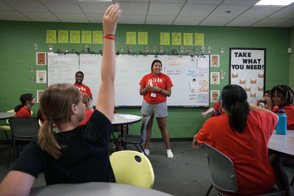 Program Specialist Andrea Vazquez, center, and Program Director Olivia Ray, left, lead a class discussion during a Lean In session at Girls Inc., Wednesday, July 26, 2023, in Sioux City, Iowa. A new girls leadership program from Lean In, the organization launched after Sheryl Sandberg published her book, “Lean In: Women, Work and the Will to Lead,” will help girls respond to what Sandberg calls stubborn gender inequities. (AP Photo/Charlie Neibergall)