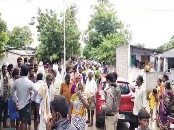 Villagers gather outside the house of 11-year-old boy who died in Prakasam district after falling in stream on Saturday. (Photo/ANI)