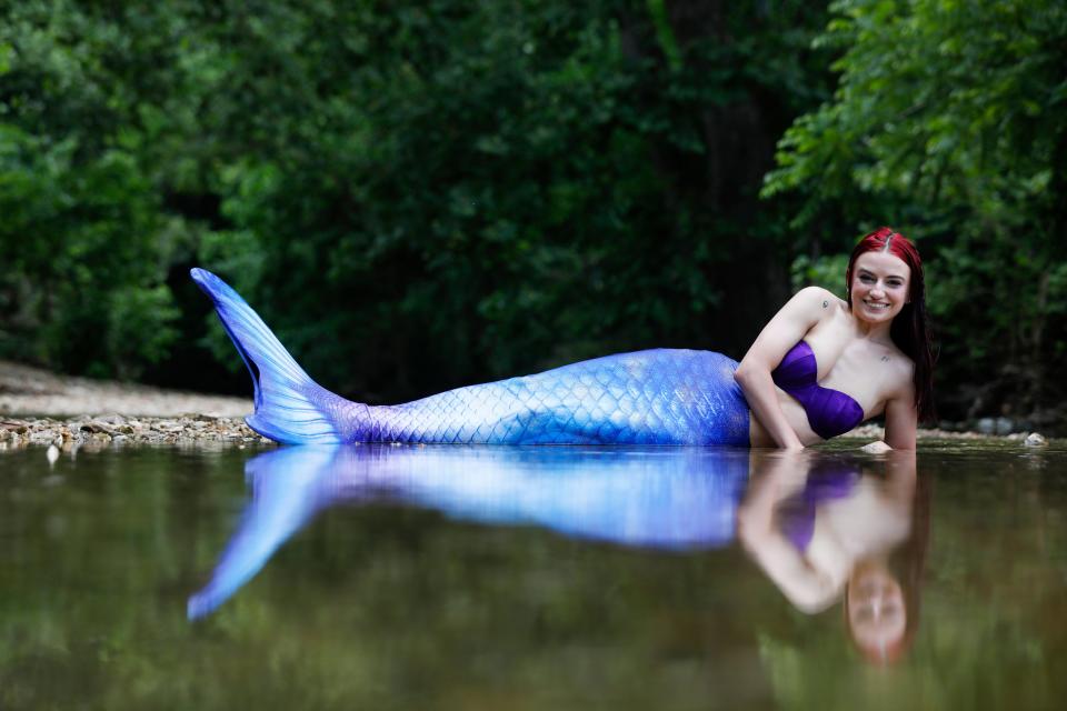 Jenae Templeton, 24, poses with her mermaid tail on at Lost Hill Park on Thursday, June 1, 2023.