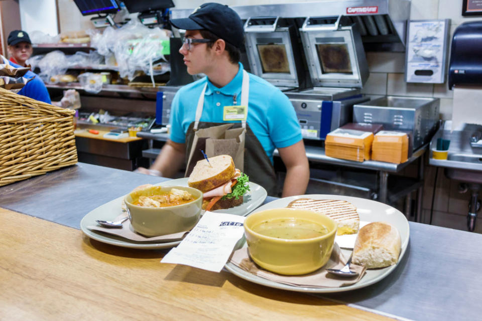 Plates of food on the counter inside Panera Bread.