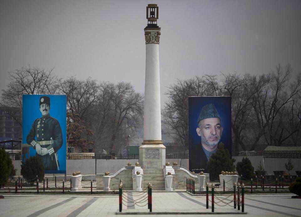 In this Saturday, March 29, 2014 photo, a giant picture of Afghan President Hamid Karzai, right, is displayed next to Afghanistan's late King Amanullah Khan on the parade ground of the Ministry of Defense in Kabul, Afghanistan. Karzai inherited a broken country when the Americans and their allies chose him more than 12 years ago as a leader they hoped could cross ethnic lines, embrace former enemies and bring Afghans together. As he prepares to leave office, Afghanistan has made great strides yet remains hobbled by a resilient Taliban insurgency and fears of a return to civil war. (AP Photo/Anja Niedringhaus)