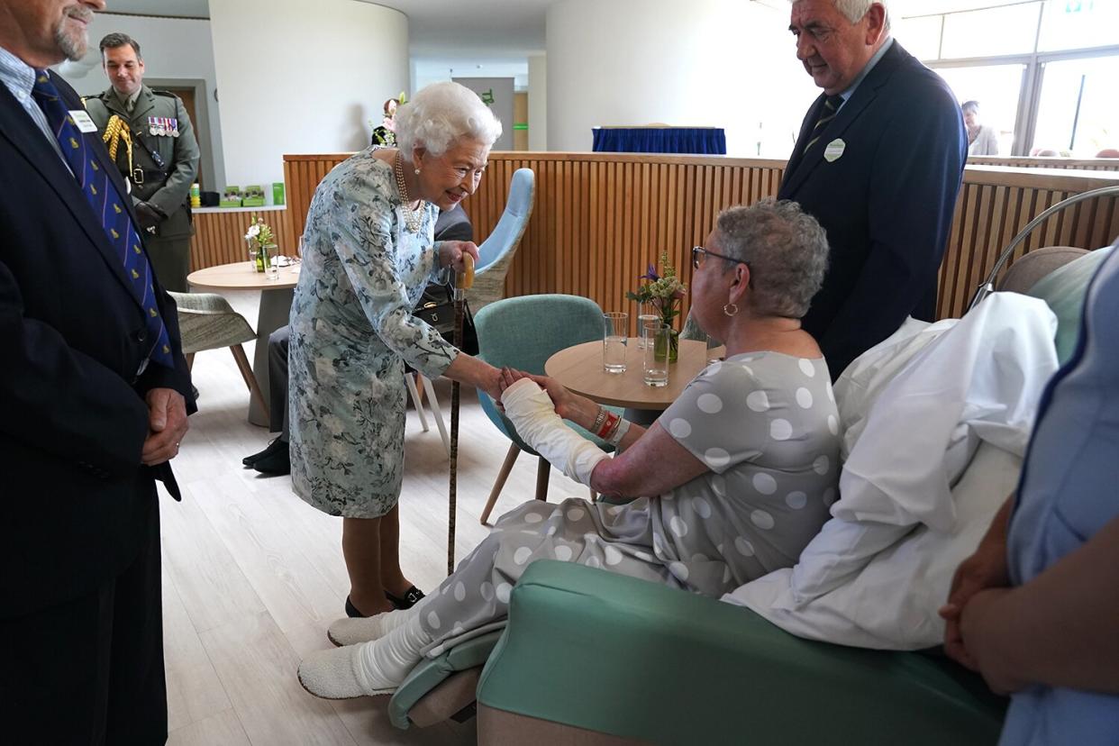 Queen Elizabeth II meeting patient Pat White during a visit to officially open the new building at Thames Hospice