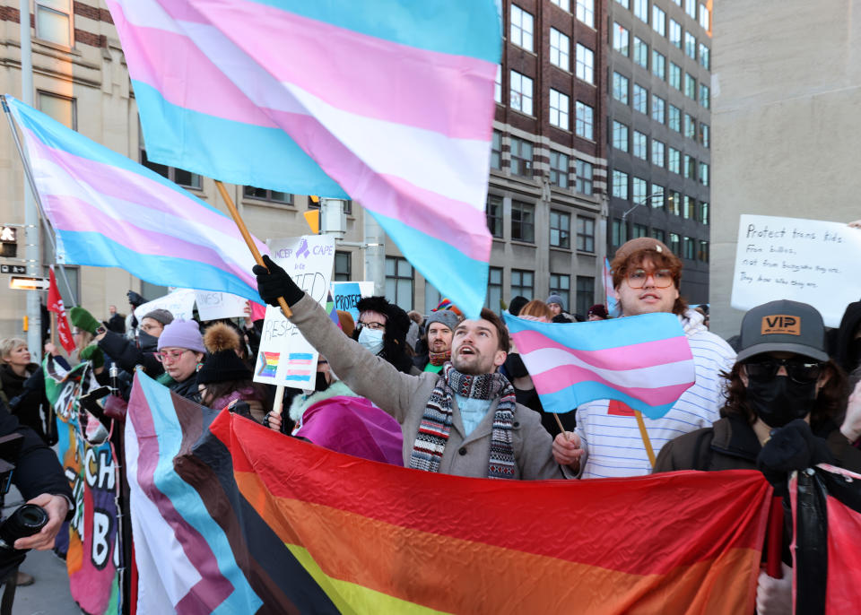 People protest Alberta Premier Danielle Smith's proposed youth transgender policies as she appears at an event in Ottawa on Monday, Feb. 5, 2024. THE CANADIAN PRESS/ Patrick Doyle