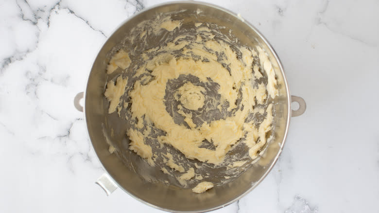 beaten butter in mixing bowl