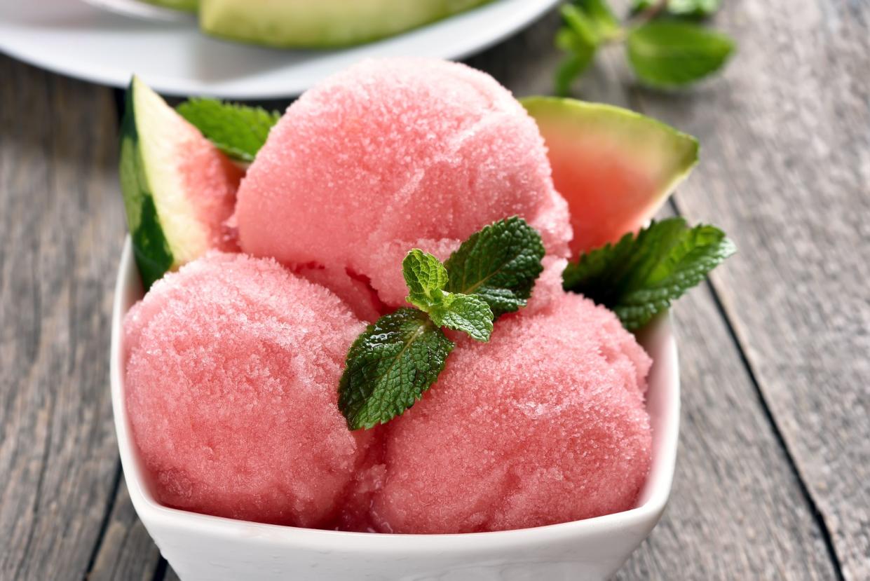 Watermelon sorbet ice cream in bowl, close up view