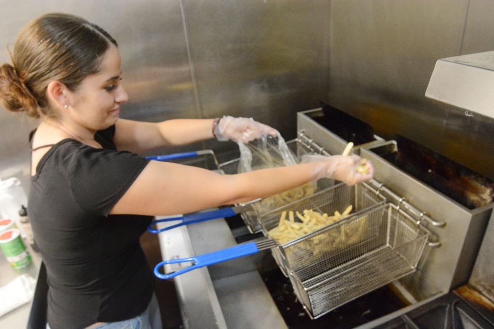 Jeannie Shear makes french fries at her Off the Griddle restaurant at the Norwich Bowling & Entertainment Center in Norwich.