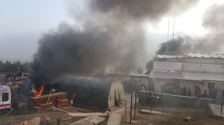 Smoke rises from a Turkish military camp after protesters stormed near Dohuk, Iraq January 26, 2019. REUTERS/Stringer