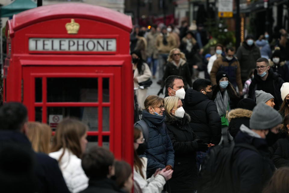 Shoppers do their last Christmas shopping in Covent Garden in London, Wednesday, Dec. 22, 2021. British Prime Minister Boris Johnson said on Monday that his government reserves the "possibility of taking further action" to protect public health as Omicron spreads across the country. (AP Photo/Frank Augstein)