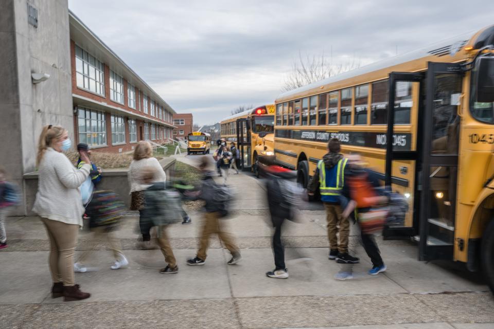 teacher seeing students off a school bus covid teaching burnout education