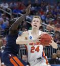 <p>Florida guard Canyon Barry (24) goes up for a shot against Virginia guard Marial Shayok during the first half of a second-round game of the NCAA men’s college basketball tournament, Saturday, March 18, 2017, in Orlando, Fla. (AP Photo/Wilfredo Lee) </p>